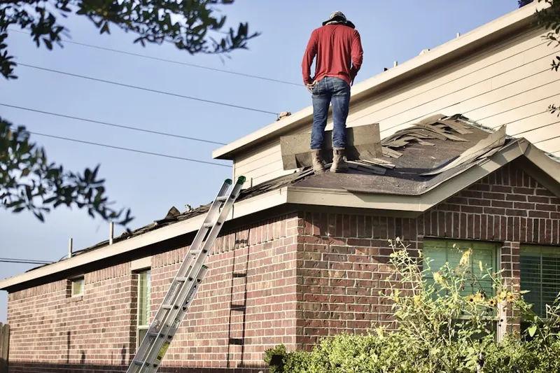 Professional roofer working on a residential roof in Dysertown